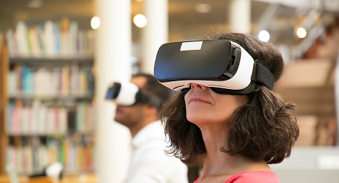 adult-female-student-watching-virtual-video-tutorial-library 1